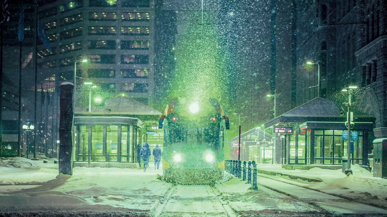 Green lit snow and train scene
