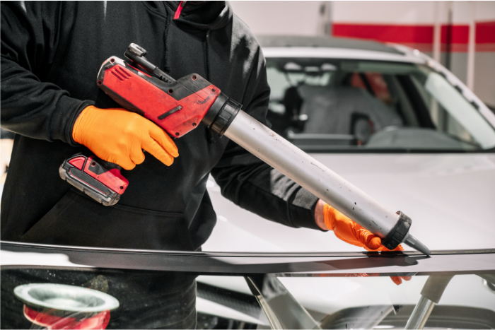 Applying Sealant to Windshield in Garage_700x467