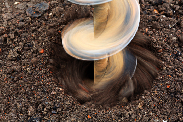 Auger drilling into earth