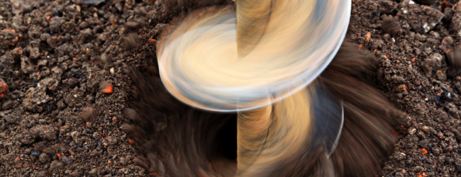 Auger drilling into earth