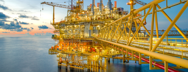 Bright yellow oil and gas rig in the ocean