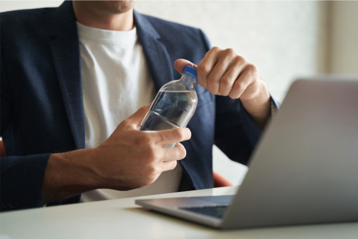 Man Opening Water Bottle - 700 × 467