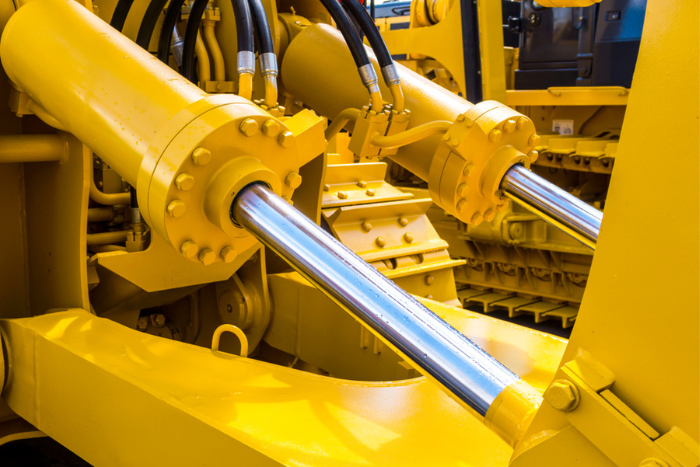 Bright yellow machine with hydraulics