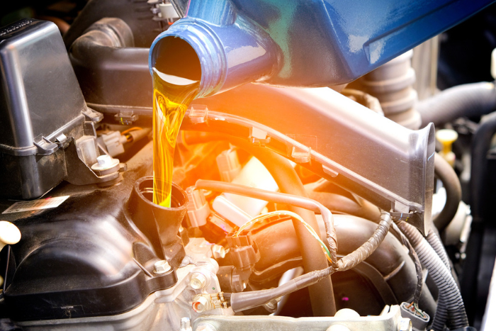 Pouring oil into an engine