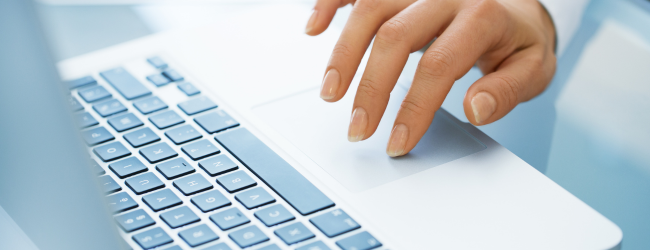 Hand on laptop keyboard