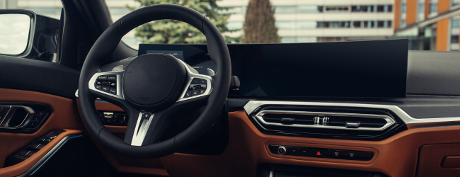 Modern car interior. White leather seats and dashboard inside modern SUV. View on the driver panel from the rear seat row